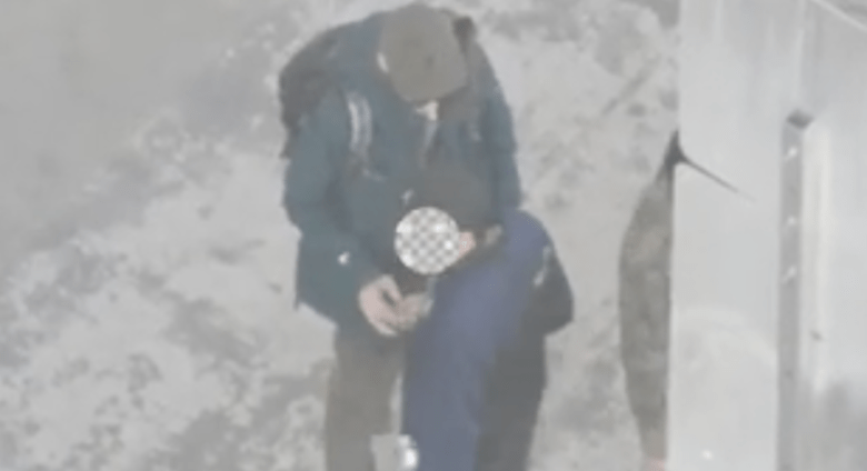 Two people stand closely together in video captured via drone, obtained by Mission Local, which police claimed showed a hand-to-hand drug transaction.