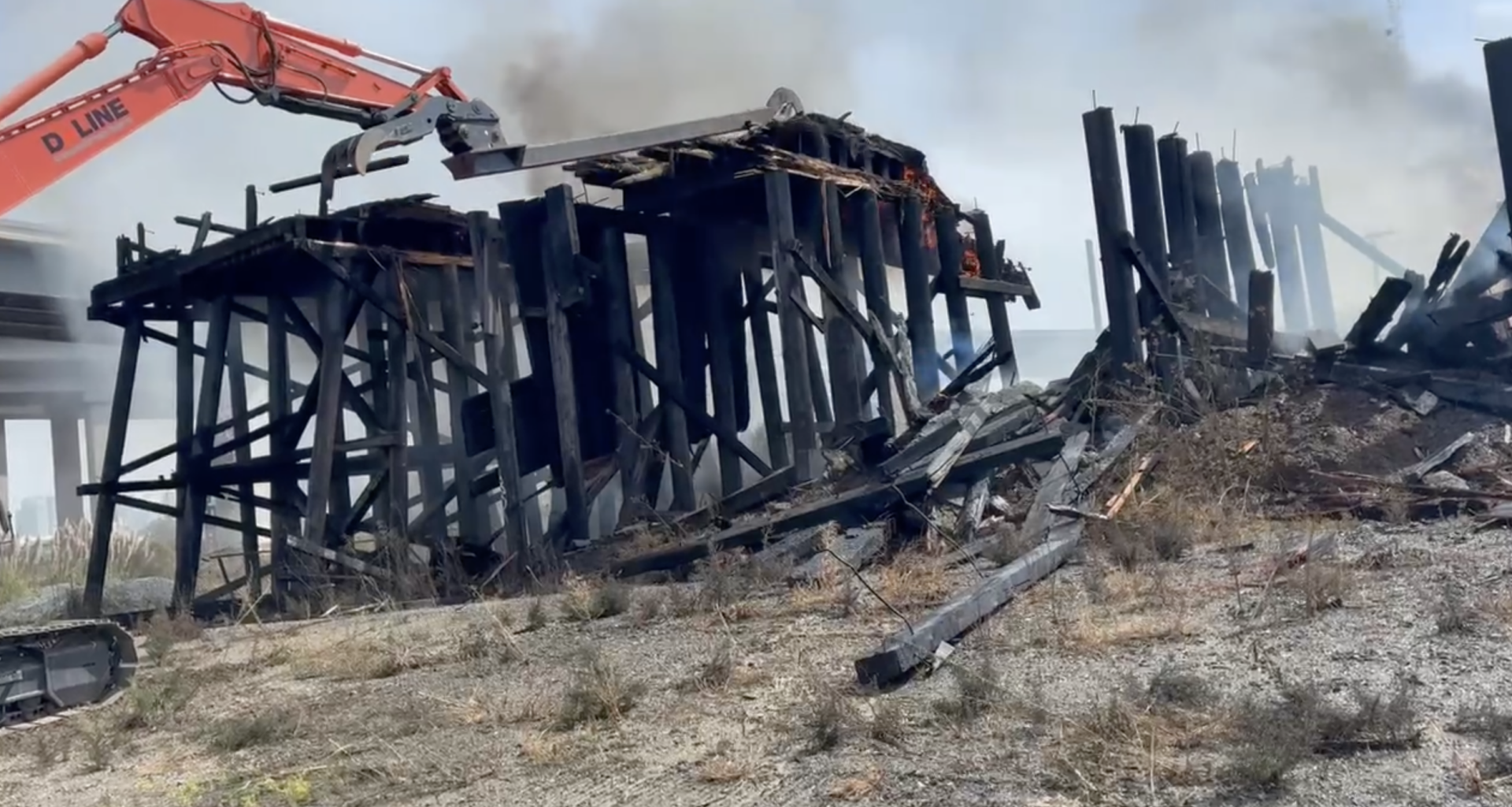Smoldering railway trestle demolished in West Oakland following massive fire
