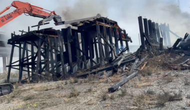 Smoldering railway trestle demolished in West Oakland following massive fire