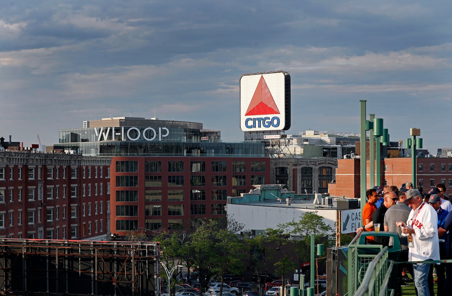 The Whoop sign took up a spot near the Citgo  sign before the latter was temporarily moved. The view includes some fans inside Fenway Park.