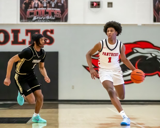 Roseville guard Carter George (1 in white jersey) drives past Macomb L'Anse Creuse North guard Julius Wilson (1) during a Division 1 regional finals game at Troy High School on March 5, 2026. (GEORGE SPITERI -- For MediaNews Group, file)