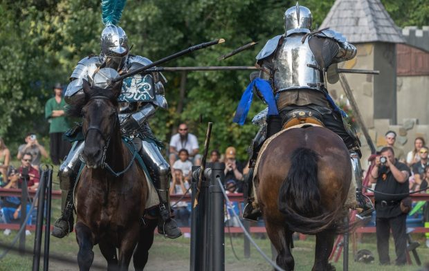 people wearing knights' armor on horses