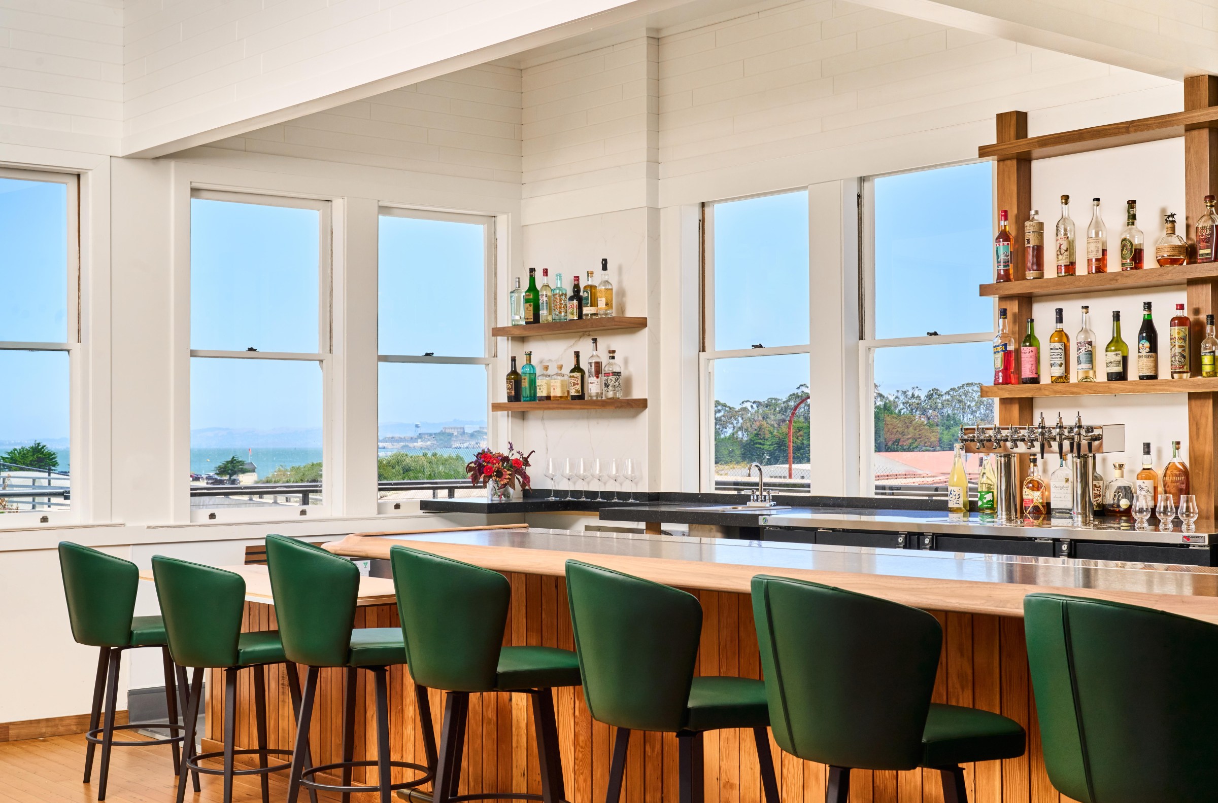 The bar area of the Mess Hall in San Francisco, with views of Alcatraz outside the window.