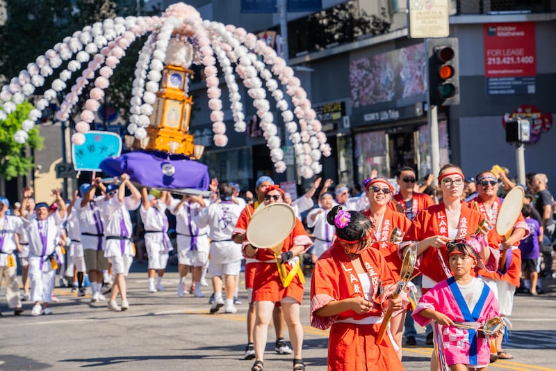 Members of Rissho Kosei Kai Buddhist Center of Los Angeles sound the fan-shaped drum, uchiwa-daiko, and dish-shaped brass gong, atarigane, followed by the mandō team.