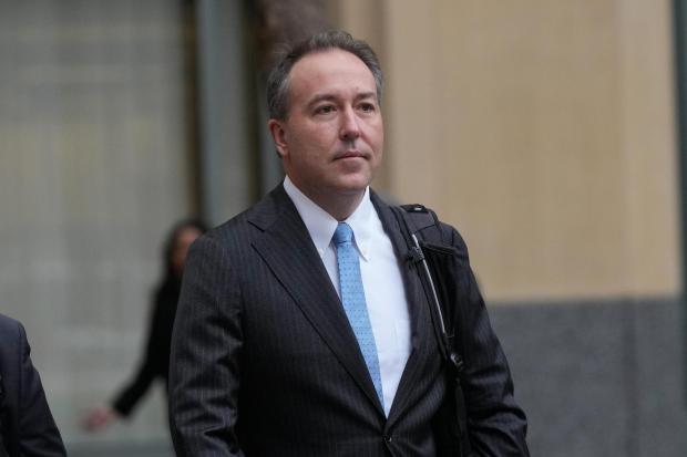 Colorado's Chief Trial Counsel Jason Slouthouber arrives at a federal courthouse.
