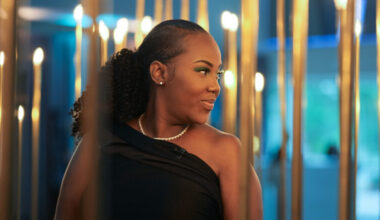 Victoria Gray looking over her shoulder and smiling at a formal event