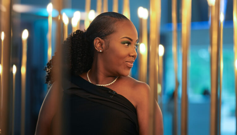 Victoria Gray looking over her shoulder and smiling at a formal event
