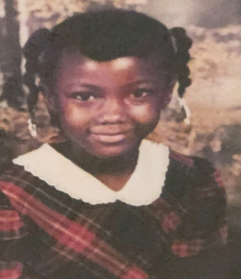 Smiling portrait of Victoria Gray at age 7