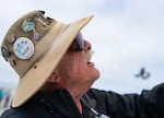 Doc Counce, a former Navy corpsman, explains how flying kites has helped his PTSD while flying a kite in a mass ascension. “It’s harmless. It doesn’t use any fuel and it makes the sky pretty,” said Counce.