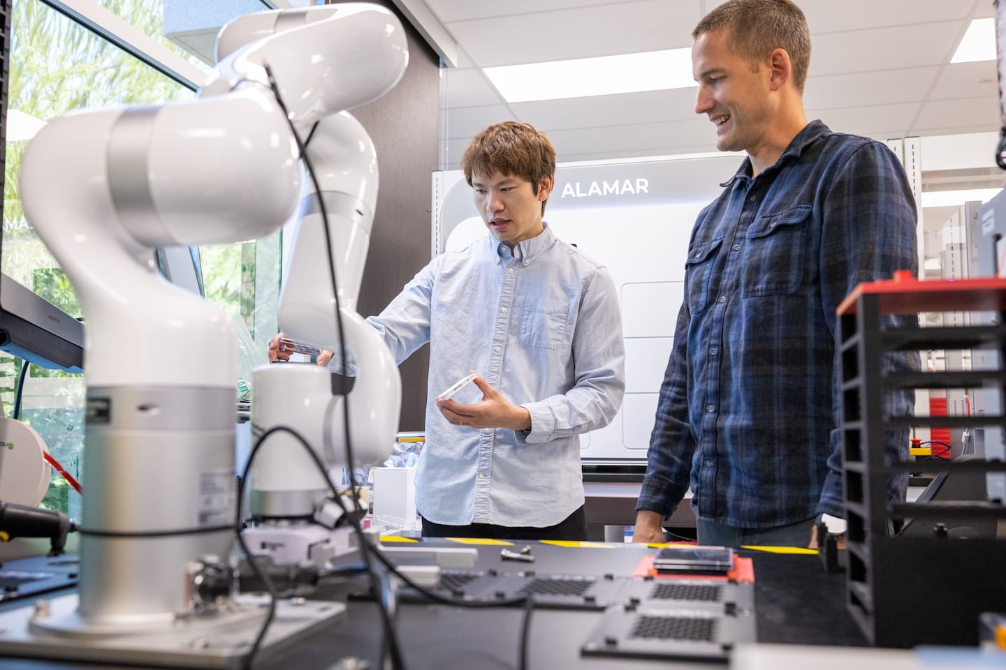 Wong and Dan Anderson, chief scientific officer, inspected trays that will be organized by a robotic arm at Integrated Biosciences.