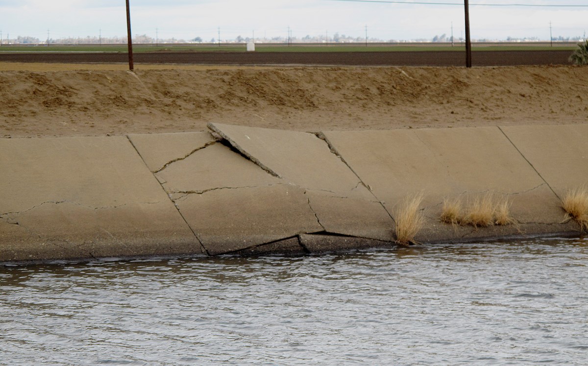 This Dec. 22, 2015, file photo shows a buckle in the lining of the Delta Mendota Canal caused by sinking land near Dos Palos, Calif.