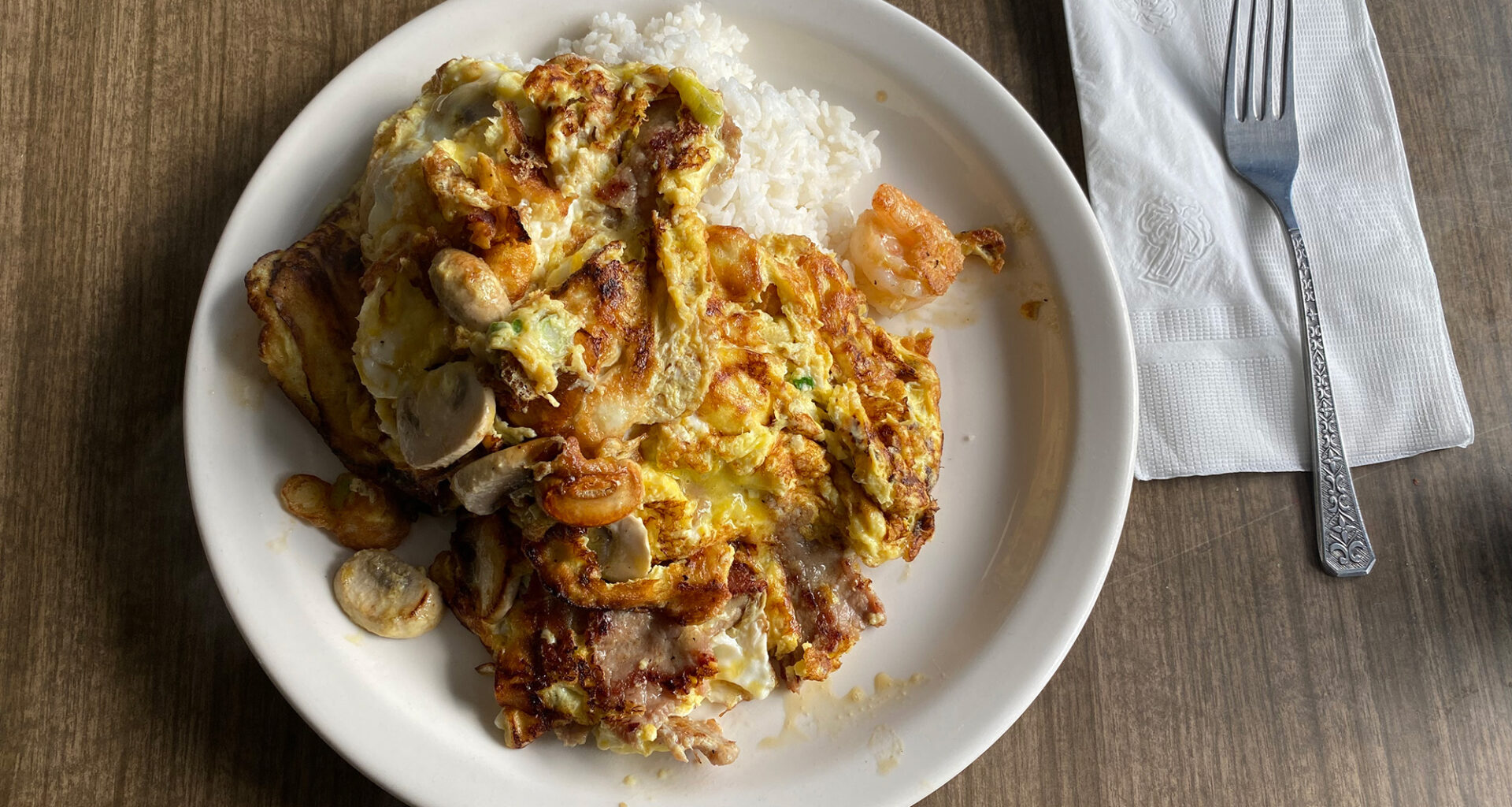 Chinese-style scrambled eggs with shrimp over rice.