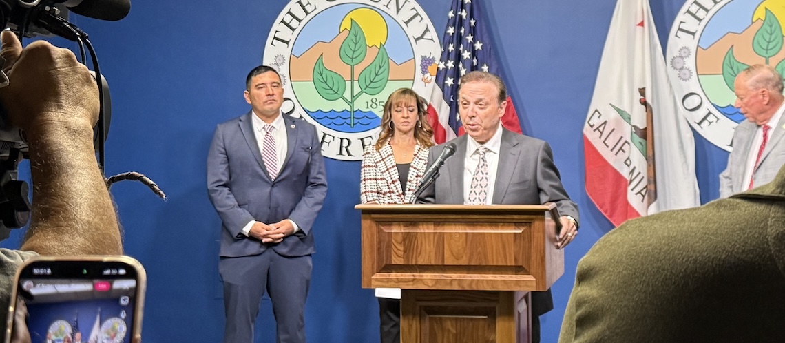 man speaking at news conference