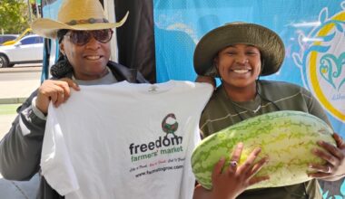 Elaine Smith, executive director of Farms to Grow, Inc., holds T-shirt for Ki’Ara LaFitte, winner of the Freedom Farmers’ Market Watermelon-Eating Contest at the season opening on July 11. Courtesy photo.