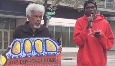 Activists Gerald Smith and Romaine Charite at 14th and Broadway in downtown Oakland near City Hall protest in support of Haitian immigrant rights. Photo by Carla Thomas