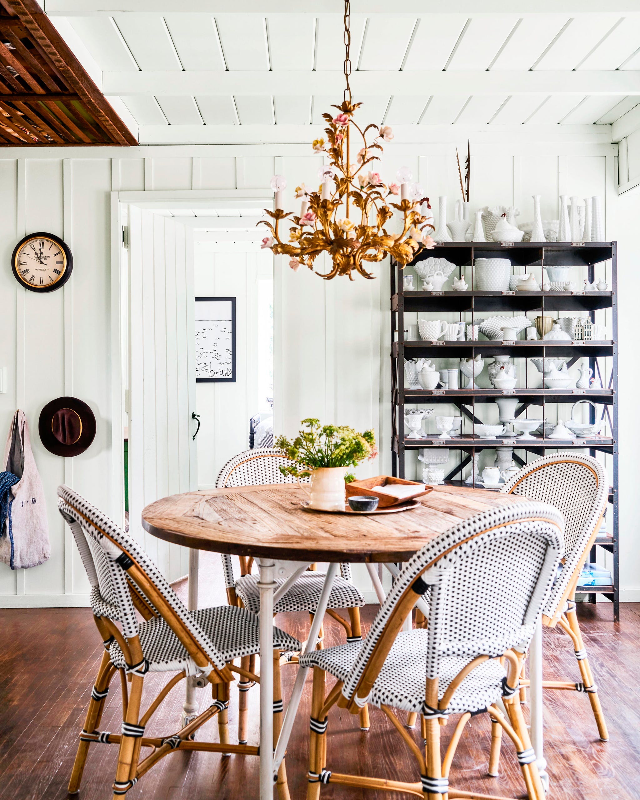 kitchen table with four bistro chairs and a shelf with white kitchenware kitchen table with four bistro chairs and a shelf with white kitchenware