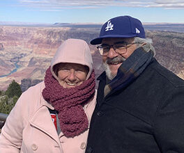 Dominick and Kathi Maggio are warmly dressed while standing in front of the Grand Canyon.