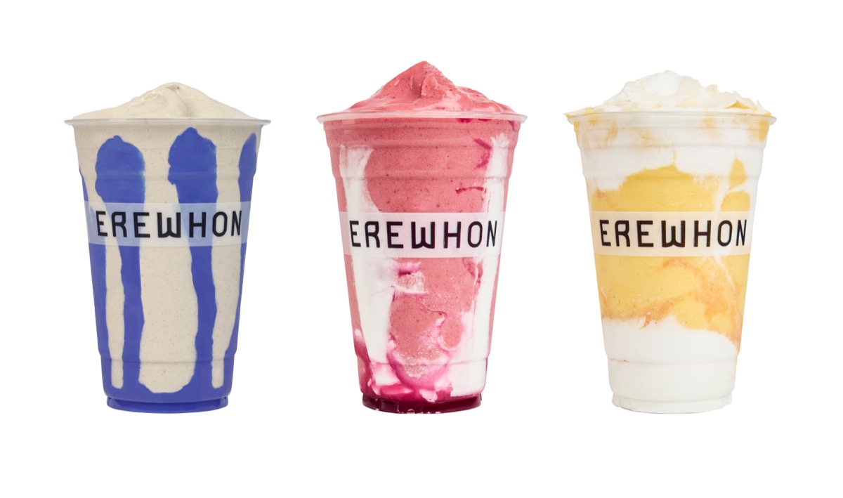 Three colorful Erewhon smoothies in clear cups with the “EREWHON” logo across the front. The left smoothie is a blue and white blend