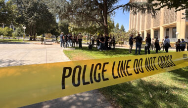 Yellow law enforcement tape cordons off a section of Courthouse Park in Downtown Fresno.