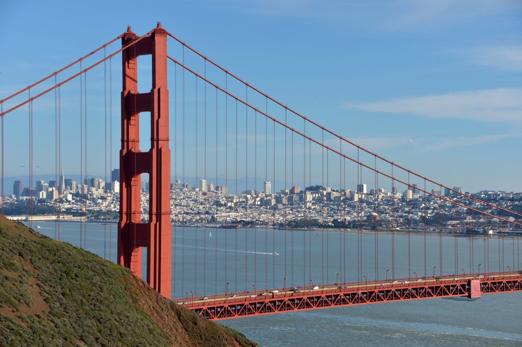 A view of the Golden Gate Bridge with the San Francisco skyline in the background.