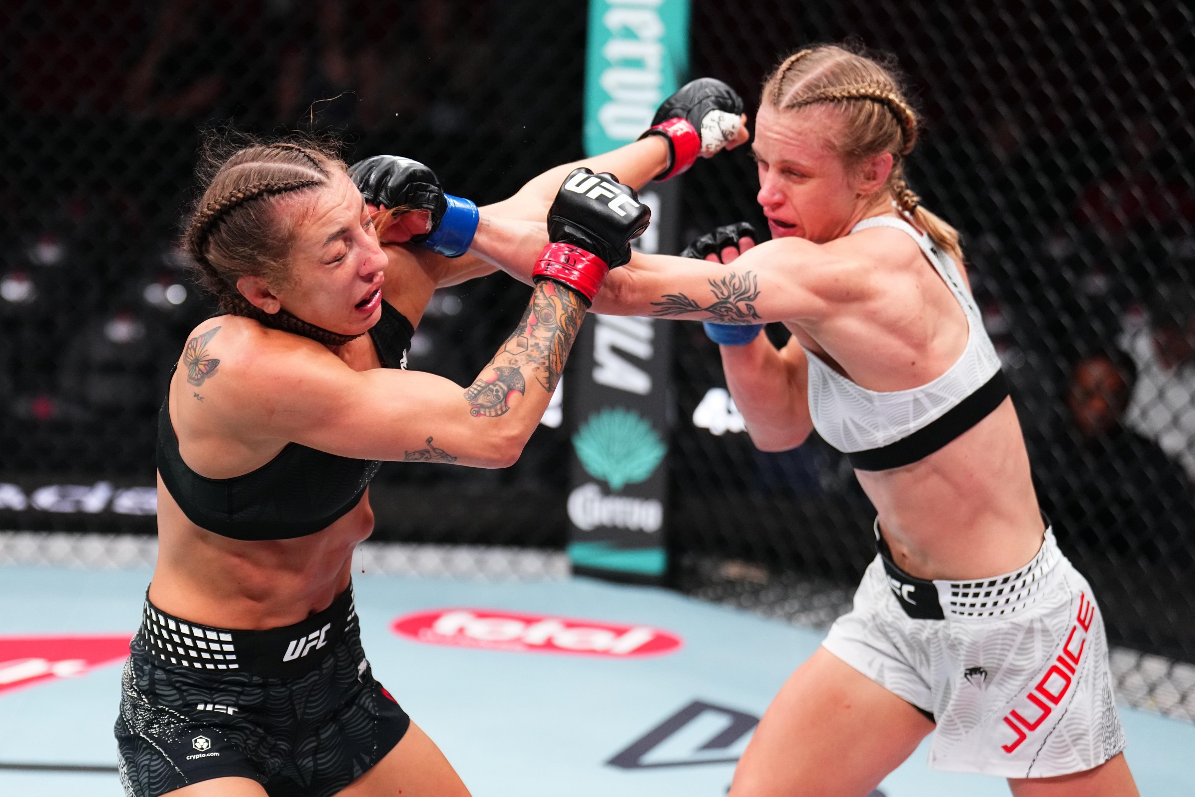 HOUSTON, TEXAS - FEBRUARY 21: (R-L) Carli Judice punches Juliana Miller in a flyweight fight during the UFC Fight Night event at Toyota Center on February 21, 2026 in Houston, Texas. (Photo by Chris Unger/Zuffa LLC)