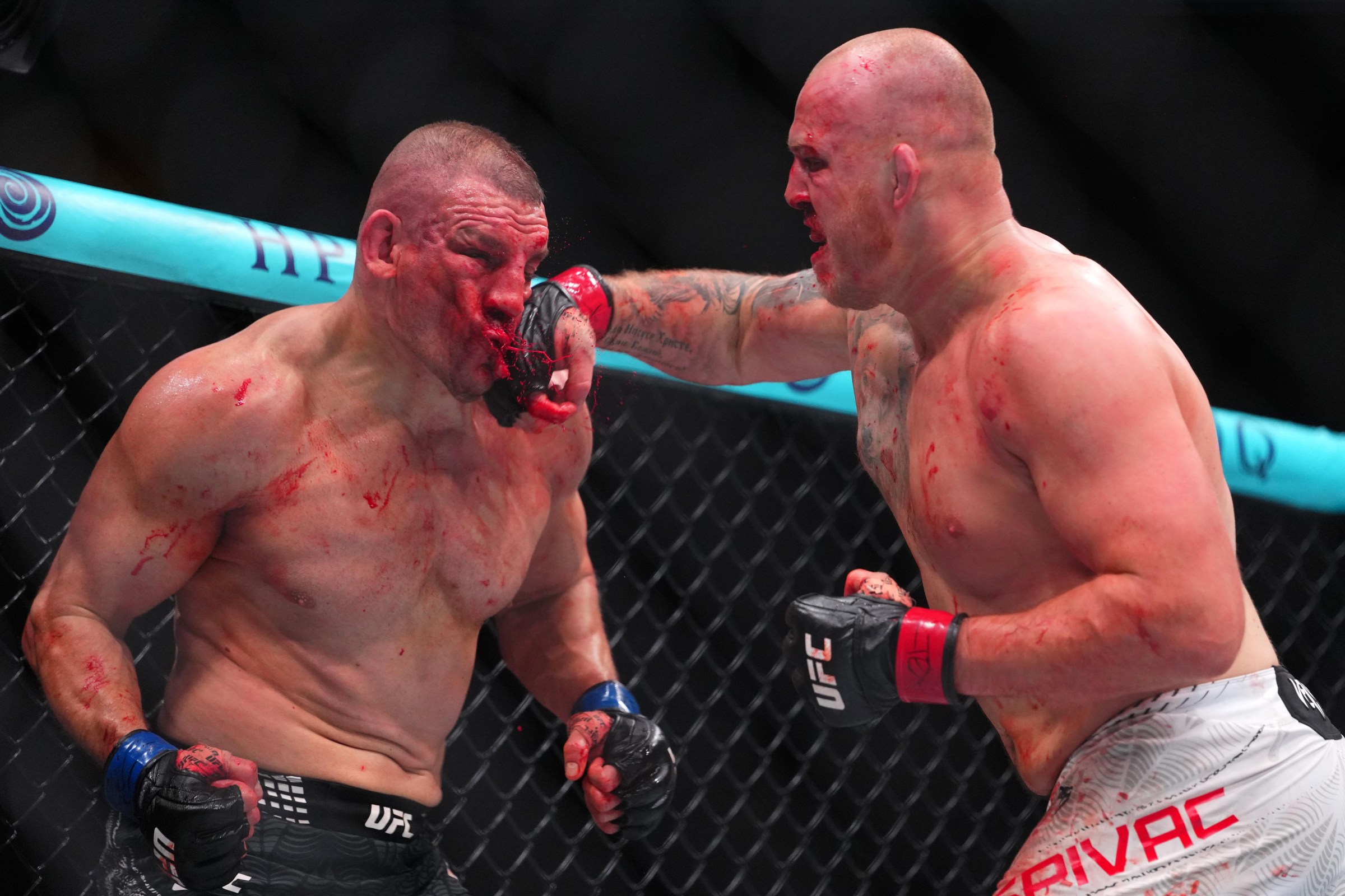 HOUSTON, TEXAS - FEBRUARY 21: (R-L) Serghei Spivac of Moldova punches Ante Delija of Croatia in a heavyweight fight during the UFC Fight Night event at Toyota Center on February 21, 2026 in Houston, Texas. (Photo by Cooper Neill/Zuffa LLC)