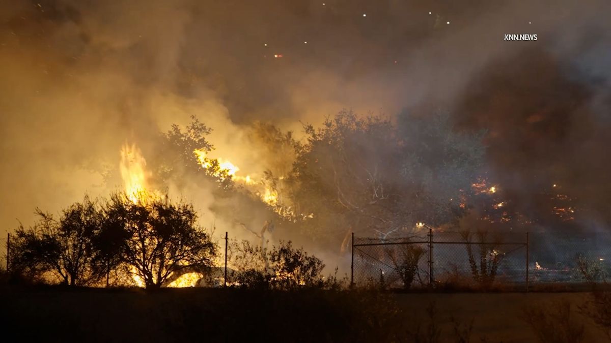 Brush fire threatens homes and school in Southern California