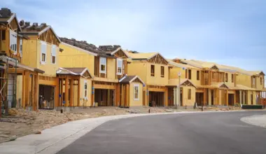 Single family homes under construction on an empty street