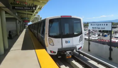 BART train at Berryessa/North San José station with the station sign visible beside the platform.