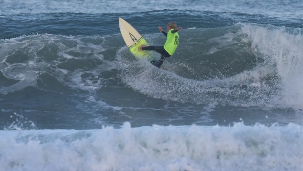 A young surfer rides a wave during last year's Menehune Junior Surf Contest in La Jolla. (M. Perreault)