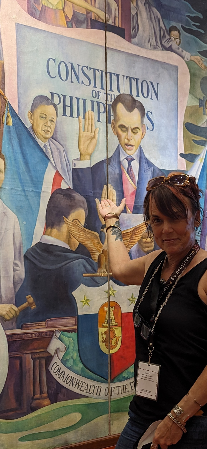 Pantoja standing next to mural