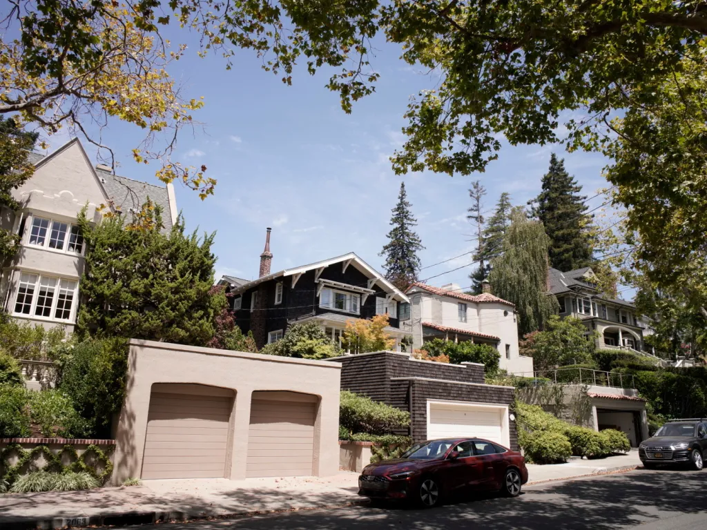 A street in Piedmont, California lined with houses and trees.