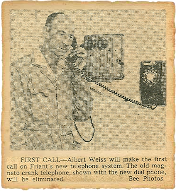 black and white photo of a man on a telephone