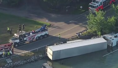 Authorities clean up fuel after semi-truck overturns into Oakland County lake