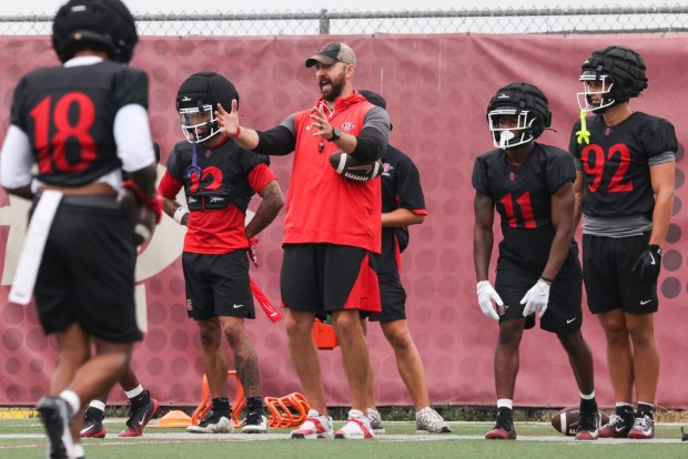 San Diego State head coach Sean Lewis offers instruction during the team's first preseason practice. (Kristian Carreon / The San Diego Union-Tribune)