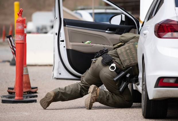 Jamul, CA - US Border Patrol officers conduct a secondary search on a vehicle that a detection dog alerted to at the Highway 94 United States Border Patrol Checkpoint on Friday, July 17, 2026, in Jamul, CA. (Luke Johnson / The San Diego Union-Tribune)