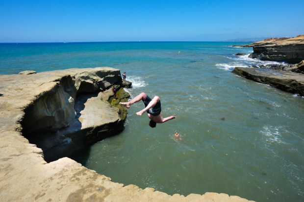 Knowing it was illegal to jump off the cliff, several individuals decided to continue diving from the cliffs on Thursday at Sunset Cliffs in San Diego, CA. (Nelvin C. Cepeda / The San Diego Union-Tribune)