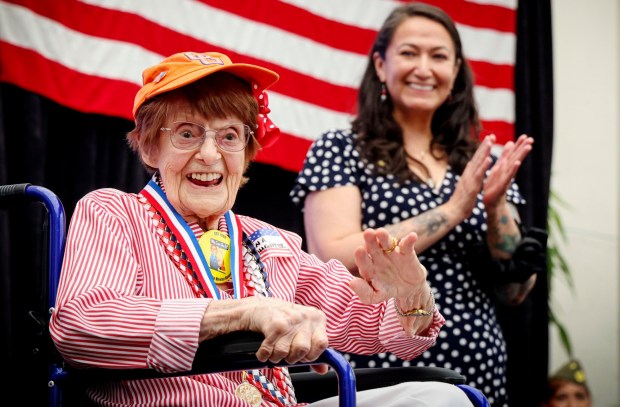 Ena Slaughter, who served in the Coast Guard and was a"Rosie"waves to attendees at the the Spirit of 45 "A Celebration of the 81st Anniversary of the End of WWII" on Sunday, August 9, 2026 at the San Diego Air and pace Museum in Balboa Park. The event, put on by Honor Flight San Diego, was held in honor of 2010 when Congress the Second Sunday in August as Spirit of '45 Dau, to celebrate August 14th, 1945 when the War ended, as well as a tribute to all veterans. (Photo by Sandy Huffaker for The San Diego Union-Tribune)
