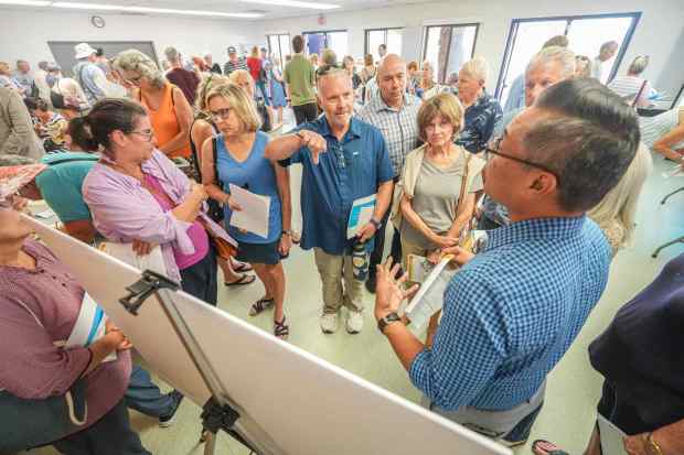 Marlon Pangilinan, far right, senior city planner, explains the affordable housing plan to the public at Standley Recreation Center on Wednesday, Aug. 12, 2026, in San Diego. (Michael Ho / For The San Diego Union-Tribune)