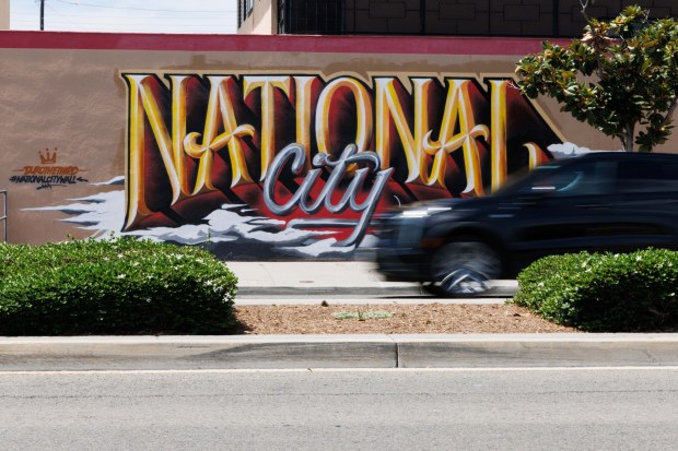 San Diego, California - A vehicle passes by a mural on National City Boulevard in National City on Saturday, Aug. 15, 2026. (Kristian Carreon / The San Diego Union-Tribune)