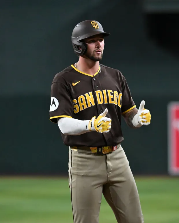 The Padres' Jackson Merrill gestures to the dugout after hitting an RBI double in the seventh inning of Thursday's victory over the Diamondbacks. (Photo by Norm Hall/Getty Images)