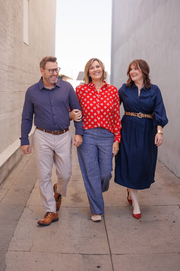 The new leadership team for Lamb's Players Theatre beginning Jan. 1, 2027, are, left to right, Chief Financial and Operations Officer Mike Bradford, Chief Philanthropy and Administration Officer Jennifer Bradford and Artistic Director Colleen Kollar Smith. (Michael Pearce)