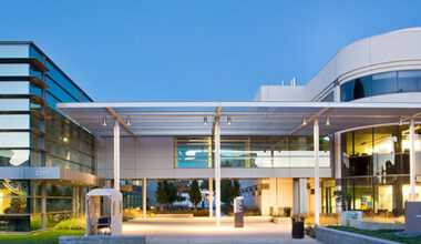UC Davis Comprehensive Cancer Center, a metal and glass building, seen from the outside.