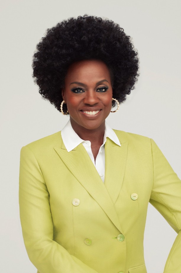 A portrait of a woman smiling into the camera.