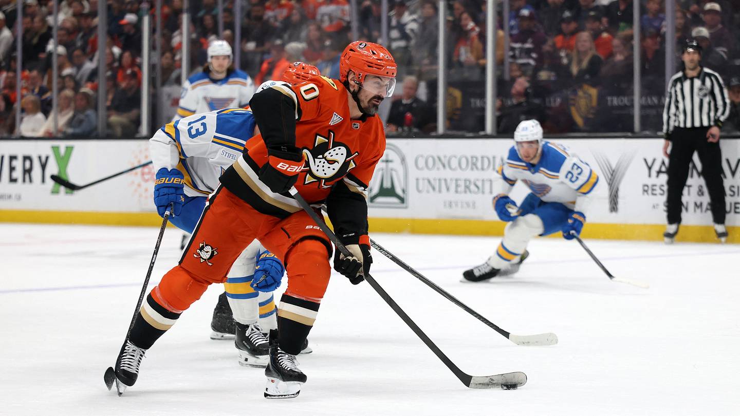 Mar 8, 2026; Anaheim, California, USA;  Anaheim Ducks left wing Chris Kreider (20) skates with the puck past St. Louis Blues right wing Alexey Toropchenko (13) during the second period at Honda Center. Mandatory Credit: Kiyoshi Mio-Imagn Images