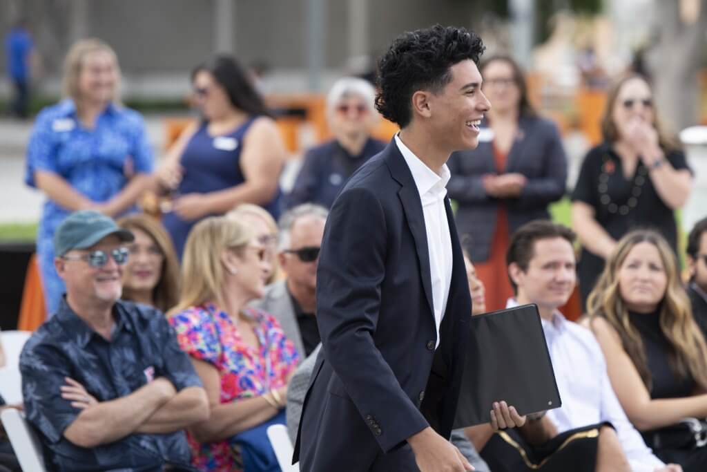 Cesar Mendoza smiles as he walks up to the podium.