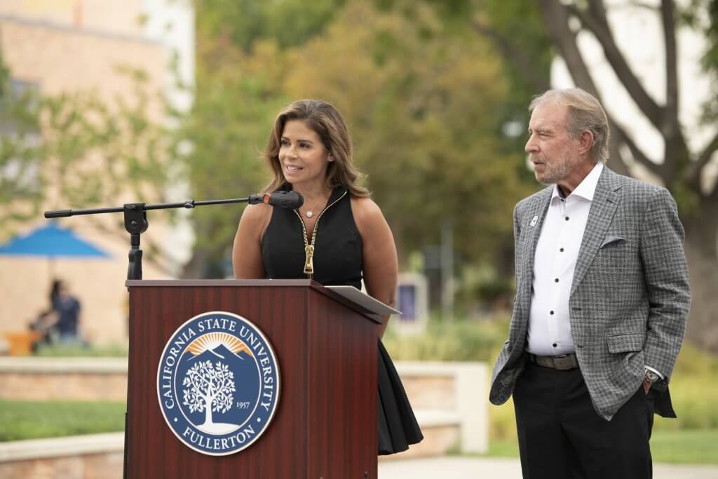 Deanna O'Brien and Scott O'Brien speak at the podium.