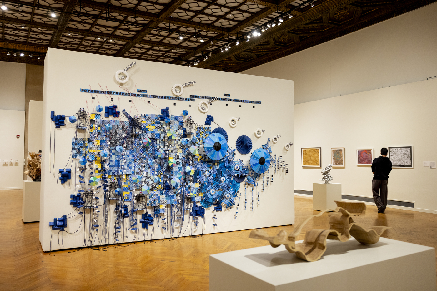 A visitor views a large blue data-visualization installation on display at the Mills College Art Museum.