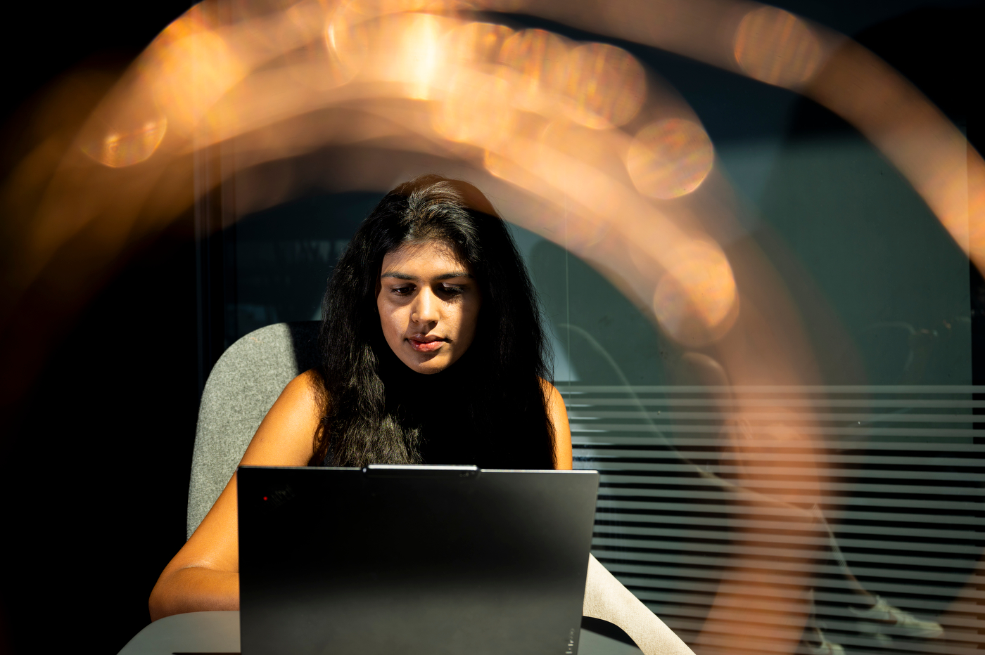 A student works on a laptop.