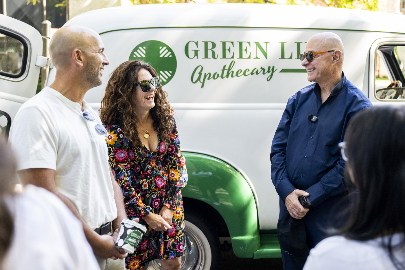 President Joseph E. Aoun and others serve ice cream samples from the Green Line Apothecary truck window.